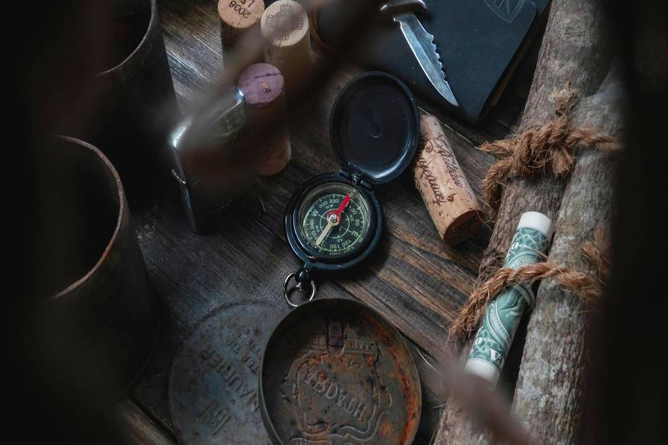 Vintage brass compass on wooden table with home decor elements